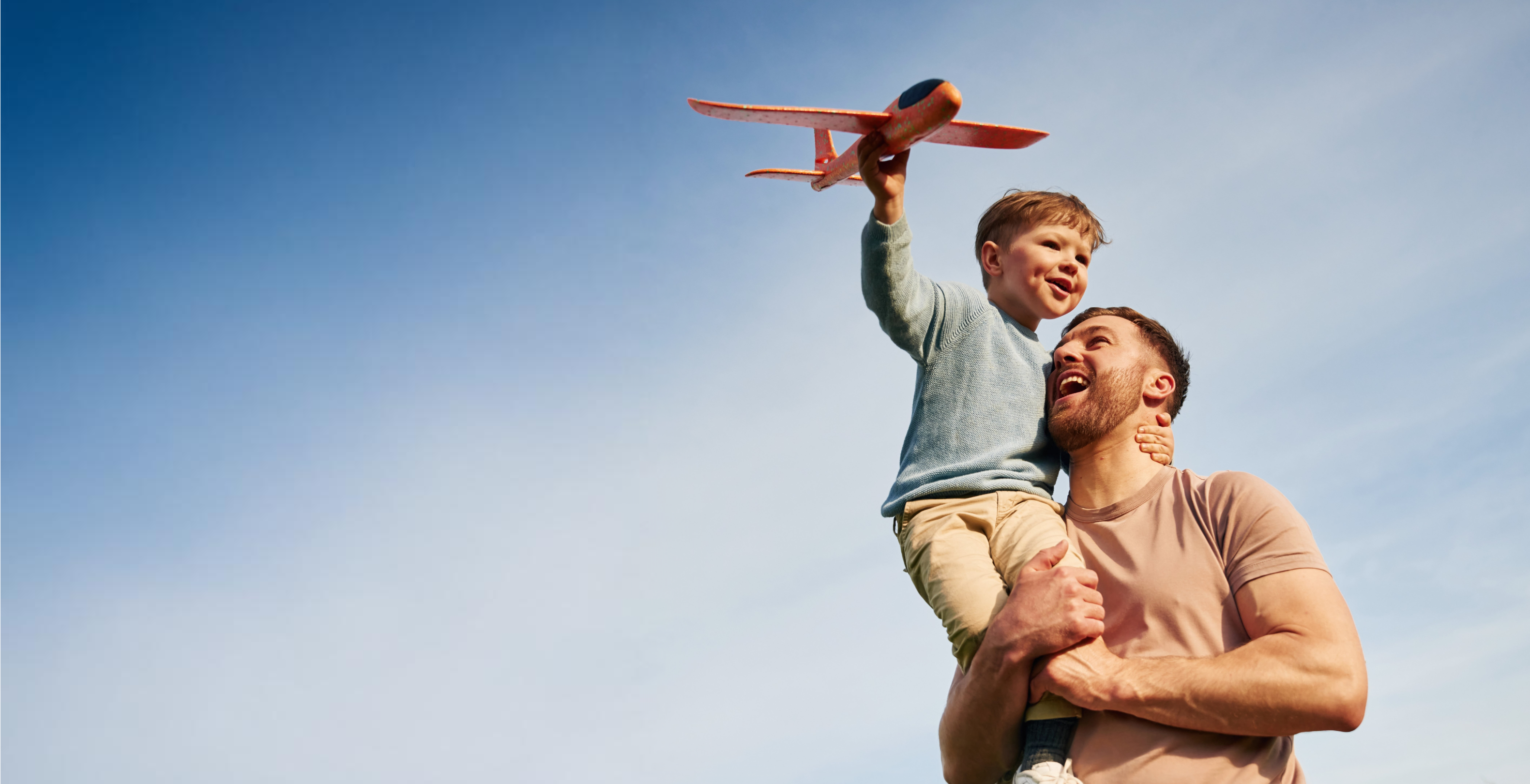 Father and son hugging and enjoying a care free moment together.